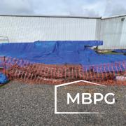 Steel Building Parts Covered by Blue Tarp