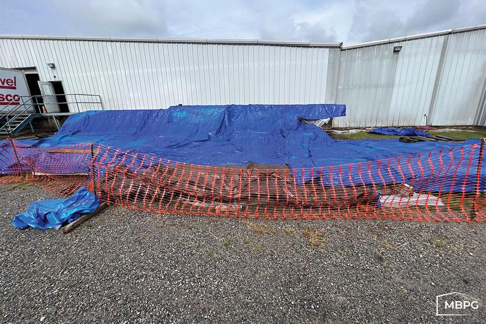 Steel Building Parts Covered by Blue Tarp