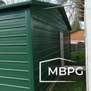 Green Steel Building with a White Door