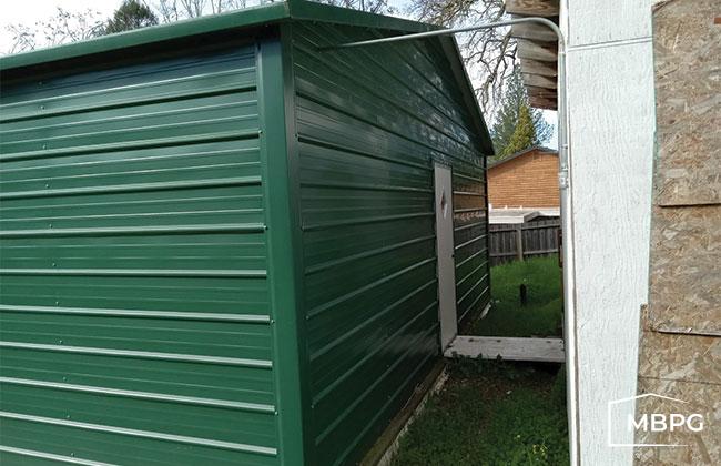 CA1770 Green Steel Building with a White Door