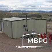 Brown Metal Building on a Dirt Lot