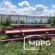 Used Red Iron Materials Loaded on grass