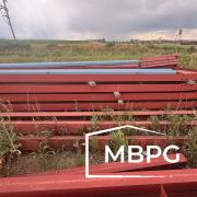 Red Iron Metal Building Materials in a Field